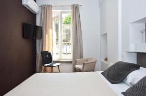 Un dormitorio con una cama y una silla y una ventana. en Rooms Patricija, en Zadar 21 fotos más