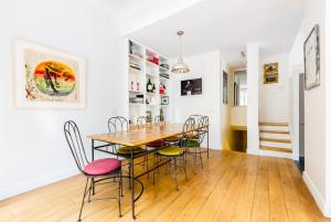 a dining room with a table and chairs at Veeve - Museum Marvel in Paris