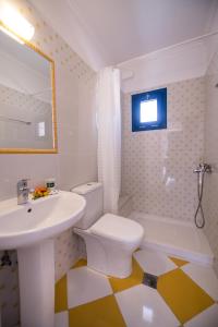a bathroom with a sink and a toilet and a tub at Akroyiali Resort in Vasiliki +37 photos