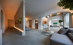 a living room with a couch and a table at VOI Marsa Siclà Essentia in Sampieri