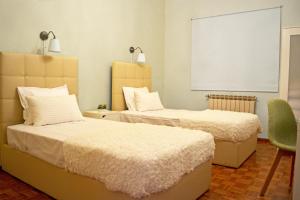 Uma cama ou camas num quarto em Alecrim Rosmaninho Guest House