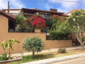 a house with flowering plants on the side of it at B&B Oui Madame in Tijuana