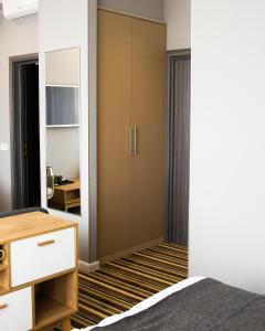 a bedroom with a closet and a mirror at Concept Hotel in Khimki