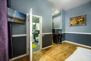 a room with blue walls and a bathroom with a toilet at Pushkinskaya Apartments in Kyiv +73 photos