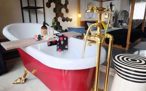 a bath tub with a wooden counter in a room at Artistic and Quirky Home with a Copper Bath and Complimentary Snack in Bangkok