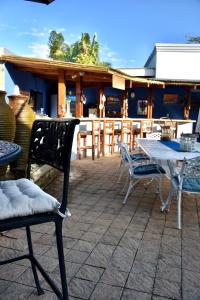 a patio with a table and chairs and a table and chairs at Turtle Bay Lodge in St Lucia