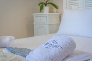 a white towel sitting on top of a bed at Agorastos Suites in Kinira