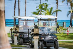 
a tour bus is parked on the side of the road at Aligio Apart-hotel & Spa - Las Terrenas in Las Terrenas
