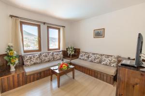 a living room with couches and a flat screen tv at Hotel Pirat in Kalkan