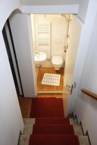 a bathroom with a staircase with a toilet and a sink at Cà Lucy in Venice