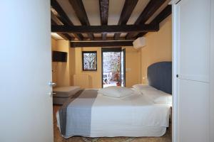 a bedroom with a white bed and a window at Cà Lucy in Venice