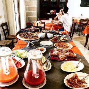 a table with many plates of food on it at Agriturismo Marconi in Porto Cesareo