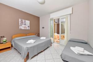 Postel nebo postele na pokoji v ubytování Albergo Del Garda