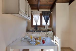 a kitchen with a white table with food on it at Polydor in Tolo