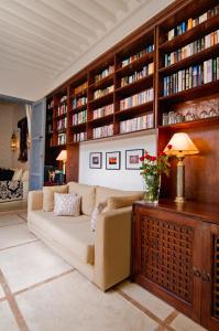 a living room with a couch and bookshelves at Riad Adore in Marrakesh