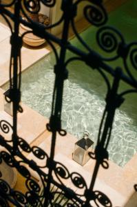 a swimming pool with a fountain in a house at Riad Adore in Marrakesh