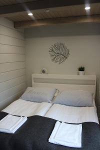 a bedroom with two beds with towels on them at Naava Chalet Lumi 301 in Ähtäri