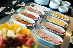 a table topped with trays of different types of food at Vila Gale Cascais in Cascais