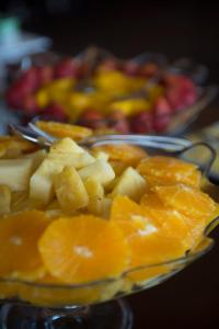 a plate of oranges and other fruit on a table at Vila Gale Cascais in Cascais