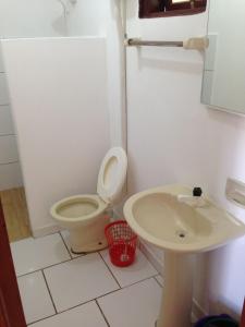 een badkamer met een toilet en een wastafel bij Garopaba Praia Club in Camacho