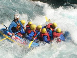 a group of people in a raft in the water at Hosteria-Cabañas Rucapillan in Choshuenco
