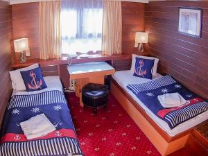 
a hotel room with two beds and a desk at Botel Albatros in Prague
