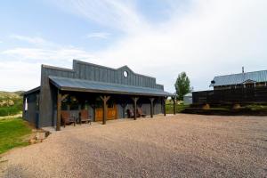 a barn with a black roof and a building at Hillside Colorado Cottages in Hillside