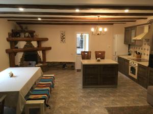 a large kitchen with a table and a counter top at EcoLodge in Novoselitsa