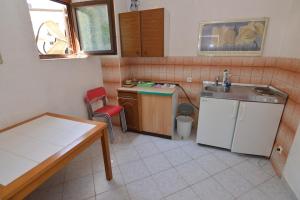 a small kitchen with a sink and a table at Arthouse Villa Palma in Poreč