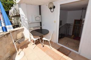 a table and chairs in a room with a balcony at Arthouse Villa Palma in Poreč