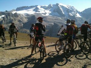 a number of people riding bikes on top of a mountain at Hotel Savoia in Canazei