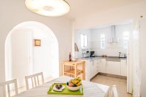 a kitchen with a table with a bowl of fruit on it at Jandia Mar in Morro del Jable