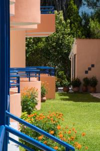 a view of a house with flowers in the yard at Akroyiali Resort in Vasiliki