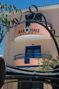 a building with a sign for a akhal sushi restaurant at Akroyiali Resort in Vasiliki