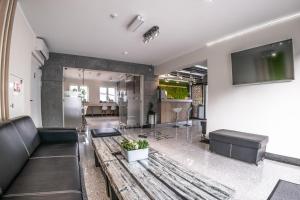 a living room with a couch and a table at Willa Plaza in Łeba