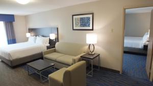 a hotel room with a bed and a couch at Holiday Inn Hotel & Suites Regina, an IHG Hotel in Regina