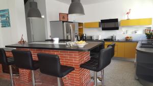 a kitchen with a brick island in the middle at Villa Tramontane in Le Grau-du-Roi