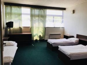 a room with three beds and a window at Hotel Koldum in Litvínov +25 photos