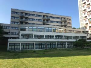 an office building with a lawn in front of it at Hotel Koldum in Litvínov