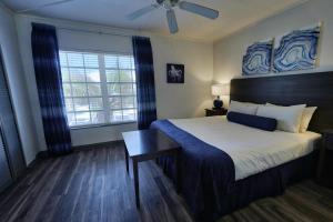 a bedroom with a bed and a ceiling fan at The Dover House Resort in Delray Beach +32 photos