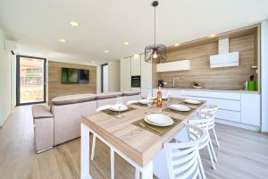 a kitchen and dining room with a table and chairs at Villa Celeia in Krk +45 photos