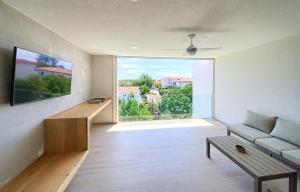 a living room with a couch and a large window at Villa Celeia in Krk