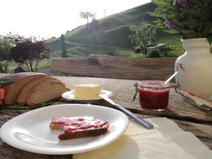 a plate of food with a piece of bread and butter at Appartement Reitlhof, Bio Berg Bauernhof in Krispl