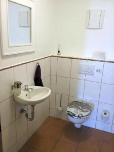 a bathroom with a sink and a toilet at Ferienwohnung S-Bahn Nähe in Schwaikheim