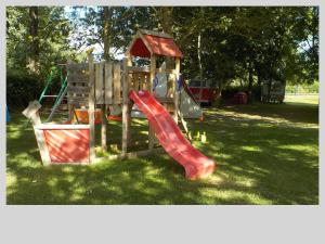 a playground with a slide in a park at L'alternatif in Huriel