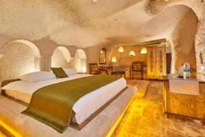 a bedroom with a large bed in a stone room at Wings Cappadocia in Uçhisar +80 photos