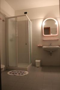 a bathroom with a shower and a sink and a mirror at albergo ristorante le fontane in Gargnano