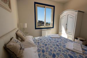 a bedroom with a bed and a window at Taormina Isola Bella Apartment - Taormina Holidays in Taormina