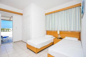 Posteľ alebo postele v izbe v ubytovaní Mon Repos Hotel