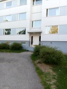 a white building with a driveway in front of it at Parantolankatu modern one room apartment in Hyvinkää +6 photos
